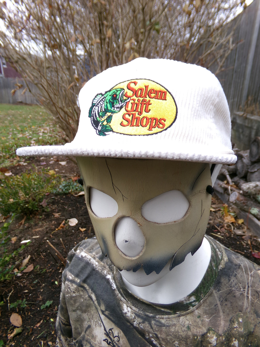 Mask with a logo on a white background, surrounded by natural elements.