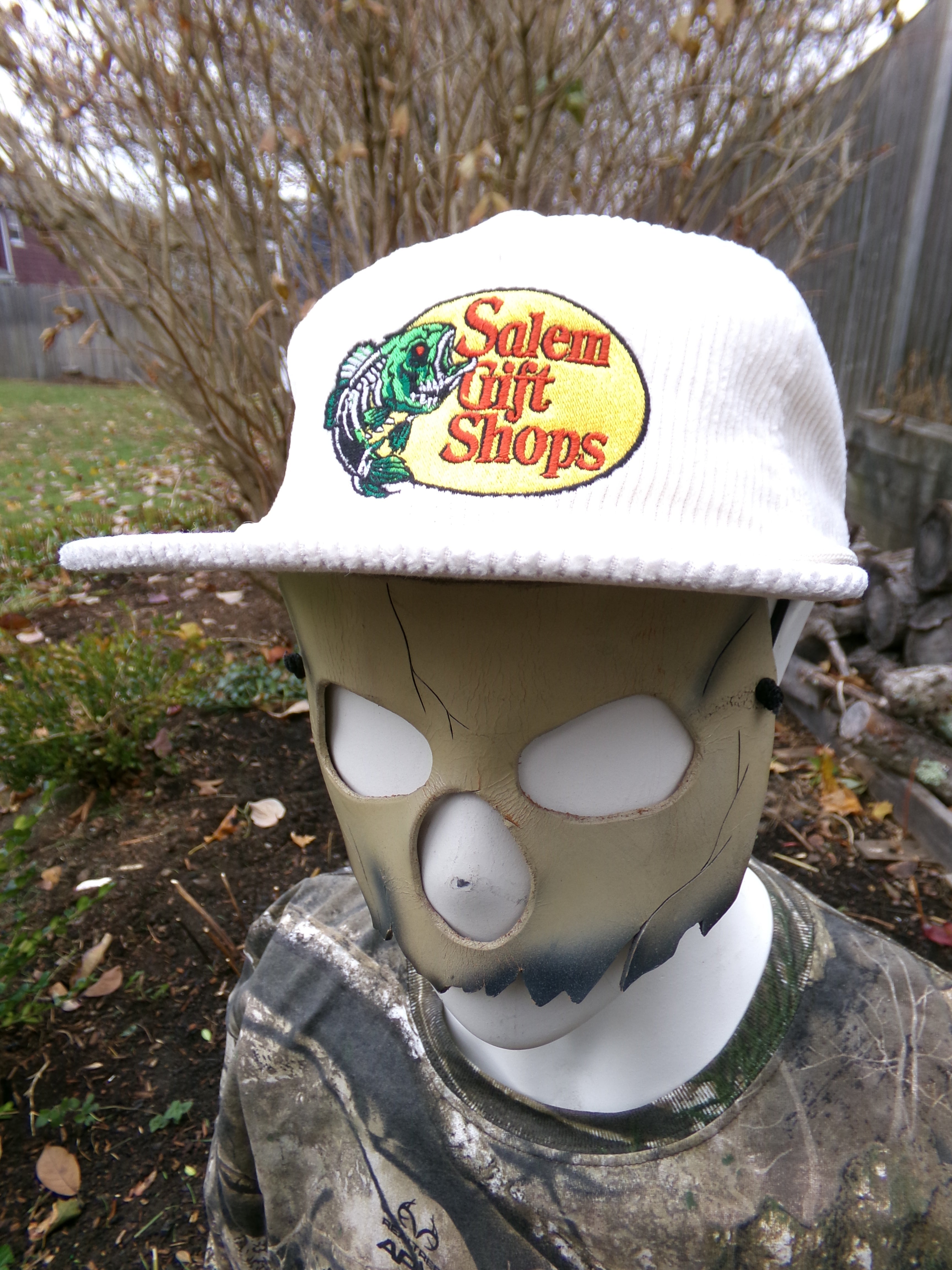 Mask with a logo on a white background, surrounded by natural elements.